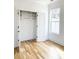A bright walk-in closet with hardwood floors, a window, and ample shelving at 3853 Delinger Dr, Mount Pleasant, SC 29466
