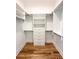 Walk-in closet with custom shelving, drawers, and wood floor at 3853 Delinger Dr, Mount Pleasant, SC 29466