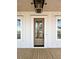 Elegant front door with glass panels and sidelights, complemented by a stylish porch light at 3853 Delinger Dr, Mount Pleasant, SC 29466