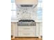 Gourmet kitchen with stainless steel KitchenAid stove, marble backsplash, and custom cabinets at 3853 Delinger Dr, Mount Pleasant, SC 29466