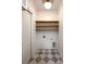 Bright mudroom with floating shelves, wainscoting, and tiled floor at 3853 Delinger Dr, Mount Pleasant, SC 29466