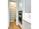 Modern kitchen featuring stainless steel ovens and a spacious walk-in pantry at 3853 Delinger Dr, Mount Pleasant, SC 29466
