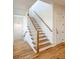 Bright stairway with oak steps, white risers, and a wooden handrail at 3853 Delinger Dr, Mount Pleasant, SC 29466