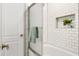 The bathroom has white subway tile, a shower-tub combo and a recessed shelf at 422 Jean Wells Dr, Goose Creek, SC 29445