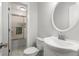 Bright bathroom featuring a sink with a round mirror and a shower-tub combo at 422 Jean Wells Dr, Goose Creek, SC 29445