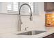 Modern stainless steel faucet and undermount sink are set in white countertops at 436 Rowley Ln, Summerville, SC 29486