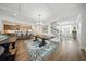 Open-concept living area featuring hardwood floors, a large table, and a view of the kitchen at 436 Rowley Ln, Summerville, SC 29486