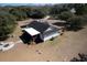 Rear aerial view of the home with a screened-in porch, patio, and fire pit at 6118 Hazelhurst Ln, Ravenel, SC 29470