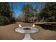 Firepit with chairs in scenic backyard featuring mature trees and landscaping at 6118 Hazelhurst Ln, Ravenel, SC 29470