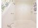 Close up of a bathtub featuring a jacuzzi, shower heads, and toiletries at 6118 Hazelhurst Ln, Ravenel, SC 29470