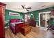 Spacious bedroom featuring a ceiling fan, elegant furniture, and sliding glass doors at 6118 Hazelhurst Ln, Ravenel, SC 29470