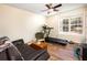 Cozy bonus room with sofa, treadmill, natural light, and wood flooring at 6118 Hazelhurst Ln, Ravenel, SC 29470