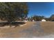 Charming white farmhouse with a long front porch, detached garage, and gravel driveway at 6118 Hazelhurst Ln, Ravenel, SC 29470
