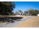 Charming home with welcoming porch, lush landscaping, and a circular driveway at 6118 Hazelhurst Ln, Ravenel, SC 29470