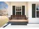 Cozy front porch featuring a classic porch swing, creating a welcoming and relaxing outdoor space at 6118 Hazelhurst Ln, Ravenel, SC 29470