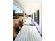 Inviting view of a spacious front porch with multiple chairs, ideal for relaxation and enjoying the scenery at 6118 Hazelhurst Ln, Ravenel, SC 29470