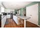 Bright kitchen with white cabinetry, stainless steel appliances, a breakfast bar, and modern fixtures at 6118 Hazelhurst Ln, Ravenel, SC 29470