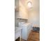 Well-equipped laundry room with sink, washer, dryer, and overhead cabinets at 6118 Hazelhurst Ln, Ravenel, SC 29470