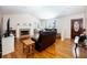 Spacious living room features hardwood floors, a cozy fireplace, and a large window for natural light at 6118 Hazelhurst Ln, Ravenel, SC 29470