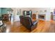 Open-concept living room with hardwood floors, fireplace, and seamless flow to the dining area and kitchen at 6118 Hazelhurst Ln, Ravenel, SC 29470