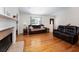 Inviting living room with hardwood floors, fireplace, and ample seating for relaxing and entertaining guests at 6118 Hazelhurst Ln, Ravenel, SC 29470
