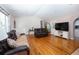 Bright living room with hardwood floors, a fireplace, and comfortable seating for relaxing and entertaining at 6118 Hazelhurst Ln, Ravenel, SC 29470