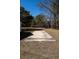 Concrete parking pad or foundation in backyard with trees and grass lawn at 6118 Hazelhurst Ln, Ravenel, SC 29470