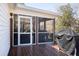 Corner of screened-in porch with barbecue grill and access door to home's exterior at 6118 Hazelhurst Ln, Ravenel, SC 29470