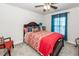 Comfortable bedroom features a ceiling fan, large bed with colorful covers and blue curtains at 613 Zinnia Dr, Goose Creek, SC 29445