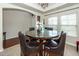 Elegant dining room featuring a round glass table, leather chairs, and ample natural light at 613 Zinnia Dr, Goose Creek, SC 29445