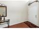 Inviting entryway with wood floors, decorative mirror and key hanging above the door at 613 Zinnia Dr, Goose Creek, SC 29445