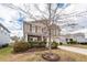 Charming two-story house with wood siding, well-maintained landscaping, and a driveway at 613 Zinnia Dr, Goose Creek, SC 29445