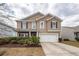 Charming two-story home featuring a well-maintained lawn, a two-car garage, and classic curb appeal at 613 Zinnia Dr, Goose Creek, SC 29445