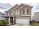 Charming two-story home featuring a spacious two-car garage and classic exterior details at 613 Zinnia Dr, Goose Creek, SC 29445