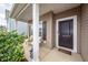 Inviting front porch with seating, enhancing the entrance to the home, with a nice manicured lawn and shrubbery at 613 Zinnia Dr, Goose Creek, SC 29445