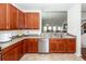 Functional kitchen area featuring dark cabinetry, stainless steel dishwasher, and a convenient breakfast bar at 613 Zinnia Dr, Goose Creek, SC 29445