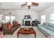 Spacious living room with fireplace, ceiling fan, and ample natural light at 613 Zinnia Dr, Goose Creek, SC 29445