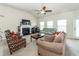 Bright living area featuring fireplace, high ceilings, ceiling fan and comfortable couches and chairs at 613 Zinnia Dr, Goose Creek, SC 29445