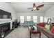 Cozy living area featuring a fireplace, ceiling fan and comfortable seating with lots of natural light at 613 Zinnia Dr, Goose Creek, SC 29445
