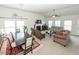 Bright, open-concept living room featuring a dining area, fireplace, and multiple seating areas for relaxation and entertaining at 613 Zinnia Dr, Goose Creek, SC 29445