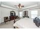 Bright main bedroom featuring an ornate dresser, ceiling fan, and two windows at 613 Zinnia Dr, Goose Creek, SC 29445