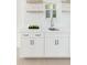 Bright bar area featuring white cabinets, modern fixtures, and an outdoor view at 5215 Cottage Lndg Dr, Summerville, SC 29485
