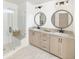 Modern bathroom featuring a glass-enclosed shower, double vanity, and contemporary fixtures at 5215 Cottage Lndg Dr, Summerville, SC 29485