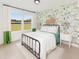 Well-lit bedroom with designer wallpaper, light wood flooring, and modern metal bed frame at 5215 Cottage Lndg Dr, Summerville, SC 29485