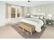 Serene bedroom with a large window, neutral tones, panel moulding, and stylish decor at 5215 Cottage Lndg Dr, Summerville, SC 29485