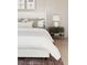 Detailed view of a serene bedroom features a stylish nightstand, decorative lamp, and neutral color palette at 5215 Cottage Lndg Dr, Summerville, SC 29485