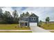 Charming two-story home featuring a manicured lawn and classic blue siding with white trim at 5215 Cottage Lndg Dr, Summerville, SC 29485