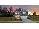 Charming two-story home featuring a covered front porch and attached two-car garage at 5215 Cottage Lndg Dr, Summerville, SC 29485