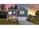 Charming two-story home featuring a covered front porch and attached two-car garage at 5215 Cottage Lndg Dr, Summerville, SC 29485