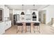 Bright kitchen features white cabinetry, stainless steel appliances, pendant lighting, and a large island with seating at 5215 Cottage Lndg Dr, Summerville, SC 29485